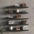 Aksel Black Floating Shelf displaying handbags, folded clothes, and decorative vases for organized, stylish wall display.