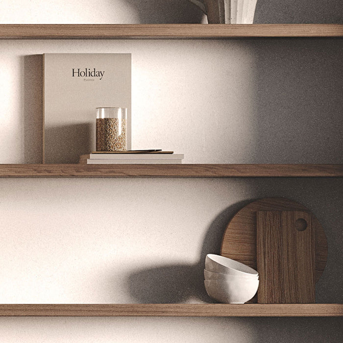 Aksel Hatch Grey Floating Shelf displaying minimalist decor with wood shelves, bowls, and a glass jar for organized wall display.