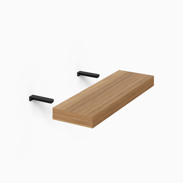 Aksel Hollow Core Single Rod Floating Shelf Bracket in matte black steel supporting a solid wood floating shelf