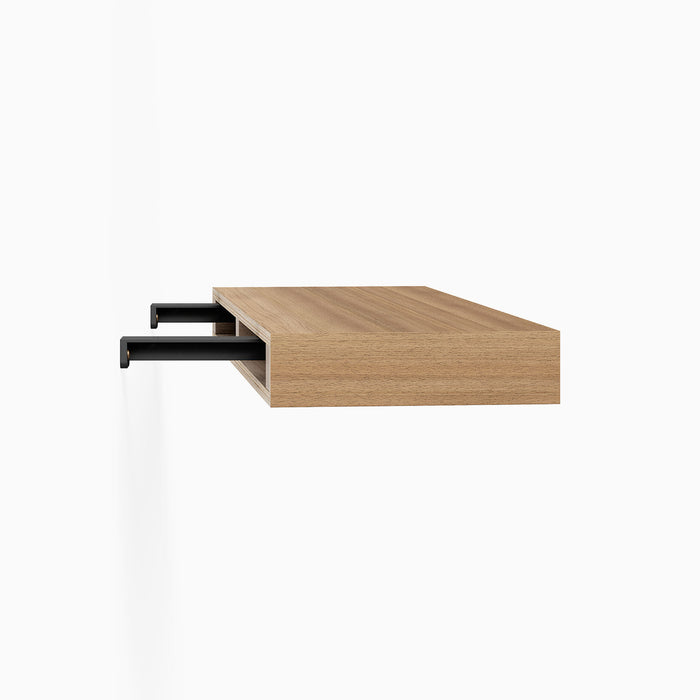 Aksel Hollow Core Single Rod Floating Shelf Bracket in matte black steel supporting a wood floating shelf core cutaway view
