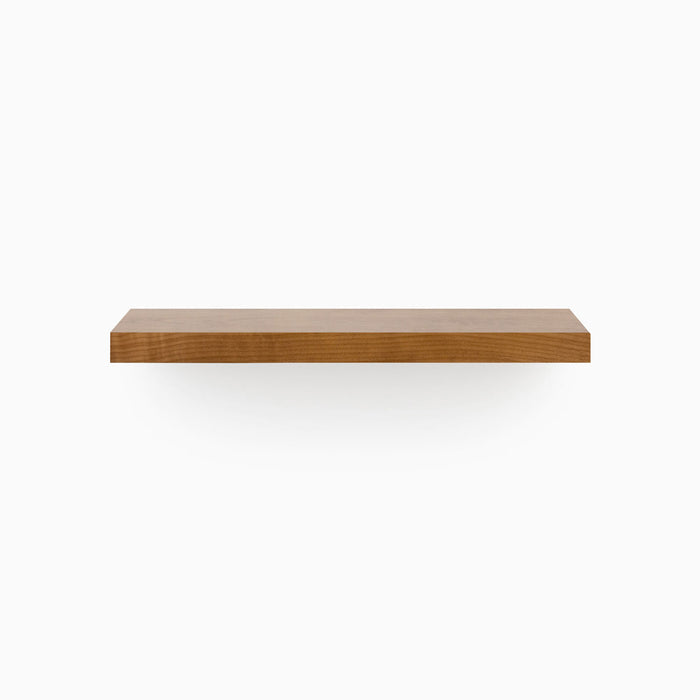 A minimalist Aksel Nutmeg Floating Shelf in warm wood tone creating functional wall display space.