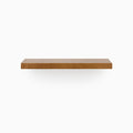 A minimalist Aksel Nutmeg Floating Shelf in warm wood tone creating functional wall display space.