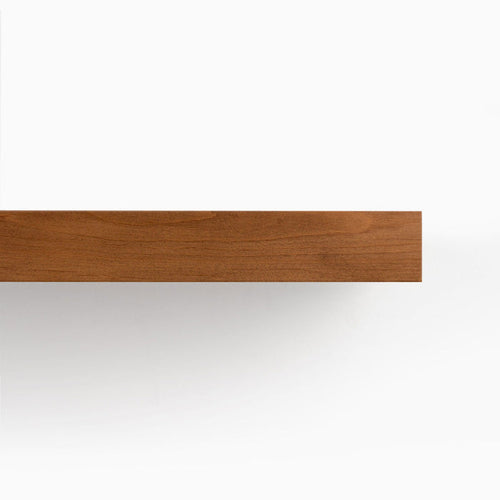 A close-up of Aksel Nutmeg Floating Shelf showing smooth wood grain and minimalist wall shelf edge design.
