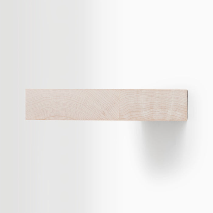 Aksel Unfinished Maple Floating Shelf mounted on wall showing minimalist, functional design and wood grain detail.