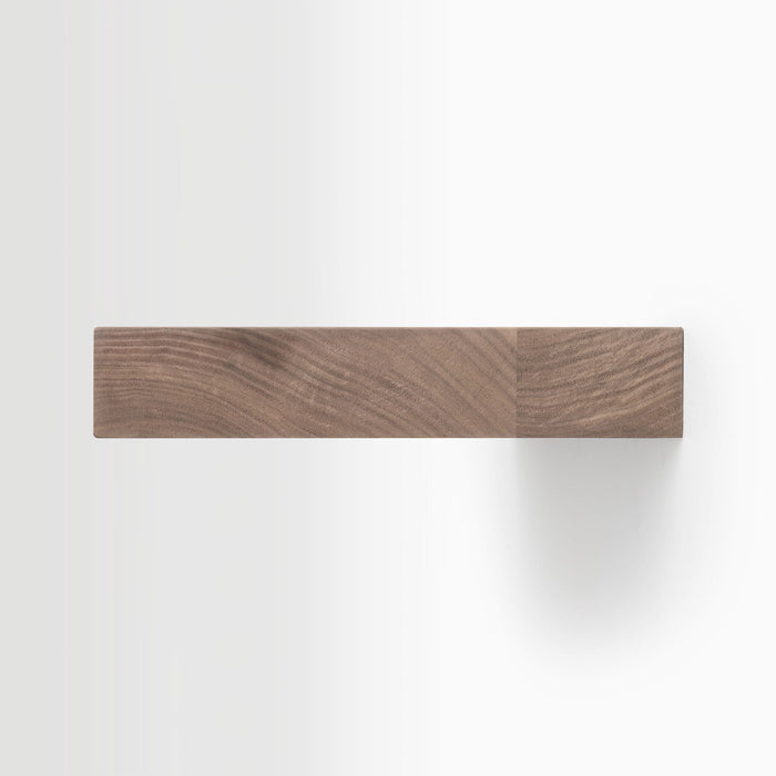 Aksel Unfinished Walnut Floating Shelf showing minimalist wood grain texture and clean wall mounting for display ledges.