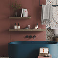 Aksel Walnut Floating Shelf mounted on a wall organizing bathroom essentials in a minimalist, stylish setup.