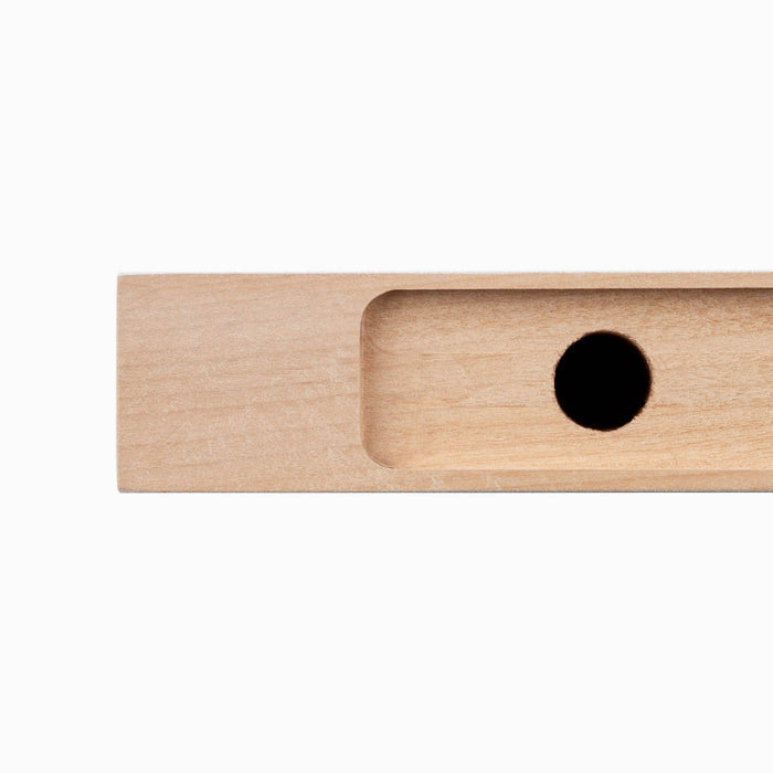 Aksel White Floating Shelf close-up of minimalist light wood with recessed hardware hole for clean wall mounting.