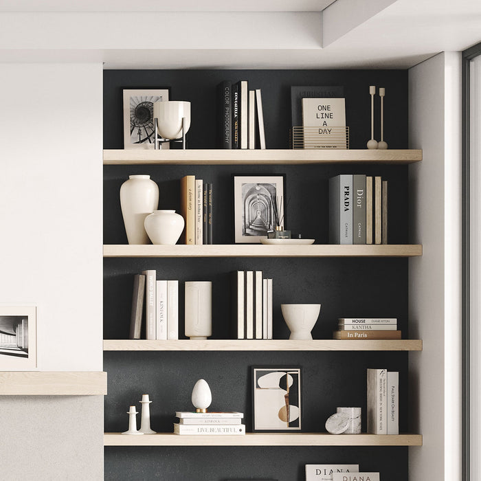 Aksel White Oak Floating Shelf installed on dark wall displaying books and decorative ceramic vases with minimalist style