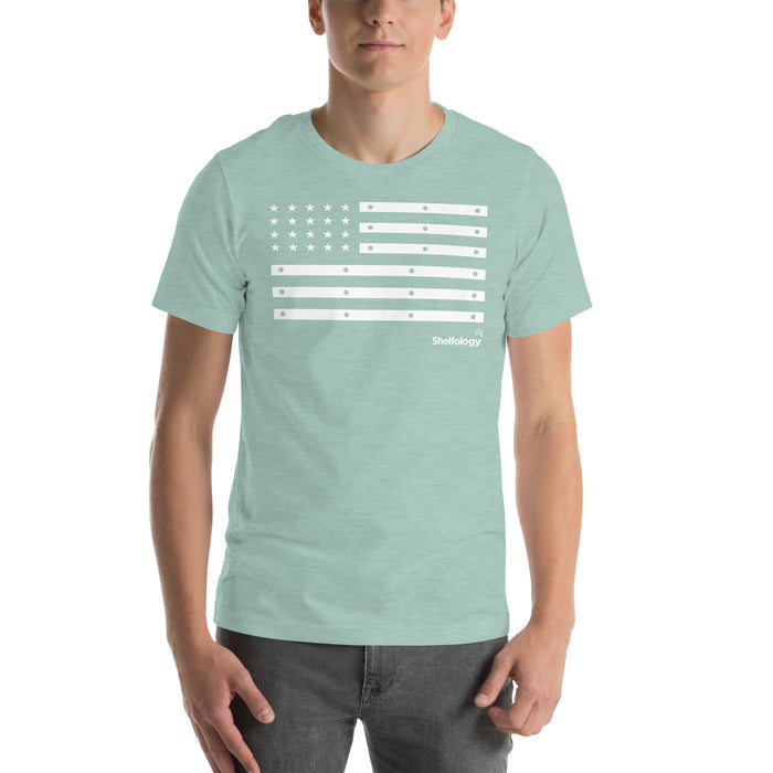 American Bracket T-shirt in dusty blue with a white shelf bracket inspired flag design and subtle Shelfology logo