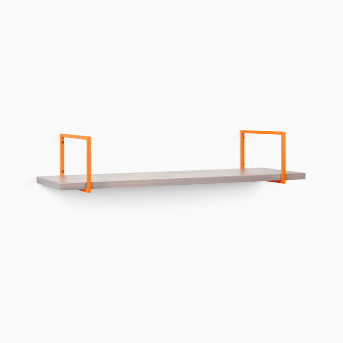 Bart Hatch Grey Wall Shelf with smooth grey wood and bright orange metal floating shelf brackets for stylish wall display