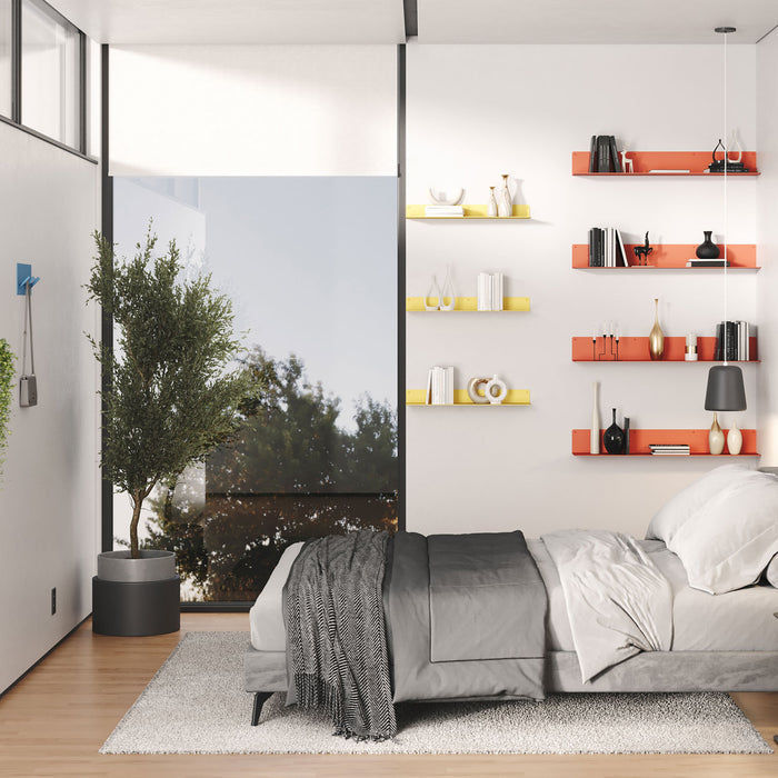 Bender FM 3 Metal Wall Shelf M2M in bright colors mounted above bed displaying decor and books in minimalist bedroom.