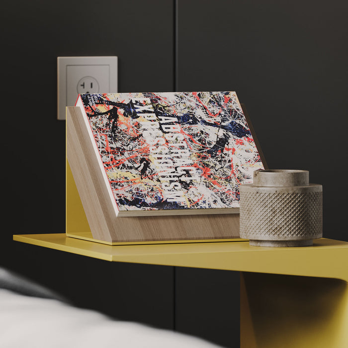 Book Wedgie Part Deux - Metal + Wood Book Rest holding a colorful abstract art book on a yellow floating shelf