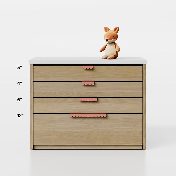 Bubble Cabinet Pull in muted coral with scalloped edge design adding a charming touch to functional cabinet hardware