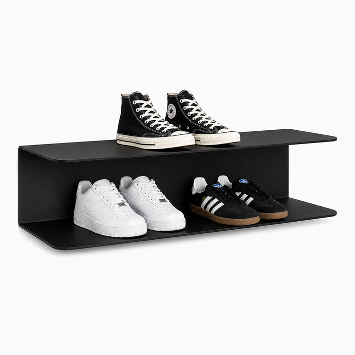 Chuck It Up Shoe Rack in matte black steel with two straight shelves featuring rounded front edges, displaying four pairs of sneakers in a minimalist style.