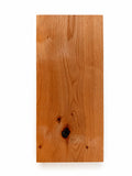Clearance — Aksel Black Floating Shelf — 22" Length x 10" Depth x 1.5" Thick in warm natural wood tone showcasing solid hardwood craftsmanship for elegant wall shelves and display ledges.