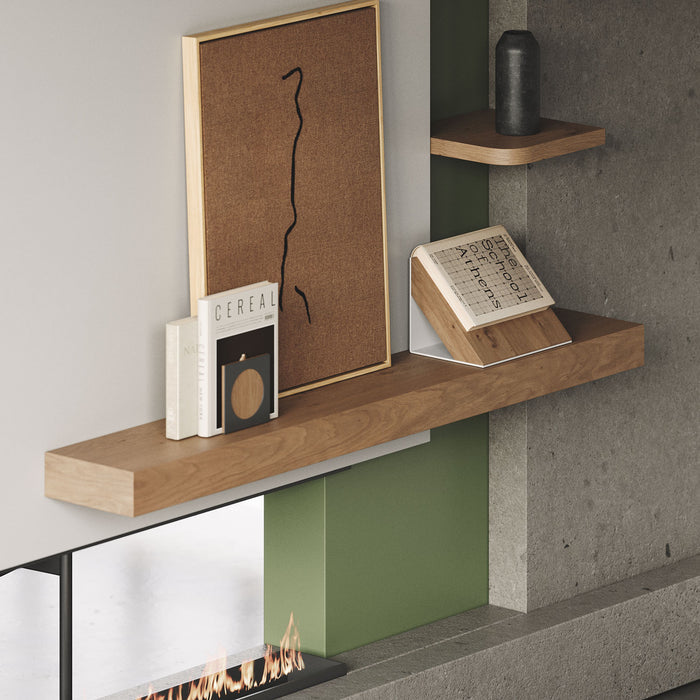 Glenn White Oak Floating Mantel displaying books and decor above modern fireplace with minimalist style