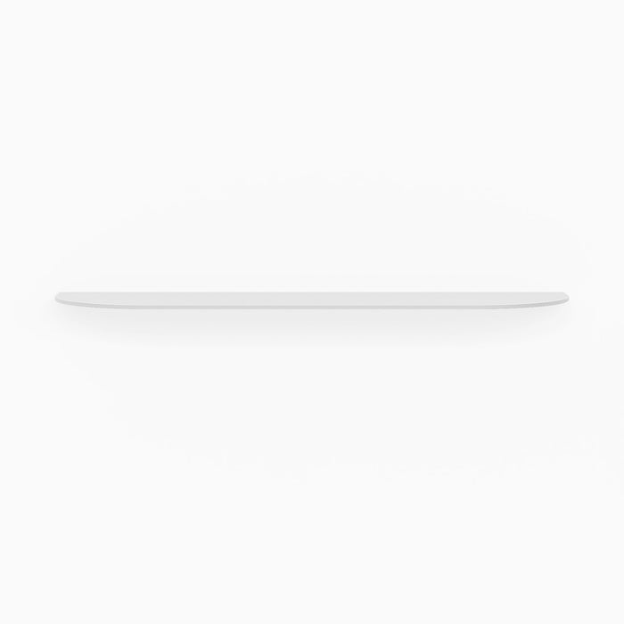 White floating shelf with rounded edges mounted on a white wall casting a soft shadow beneath