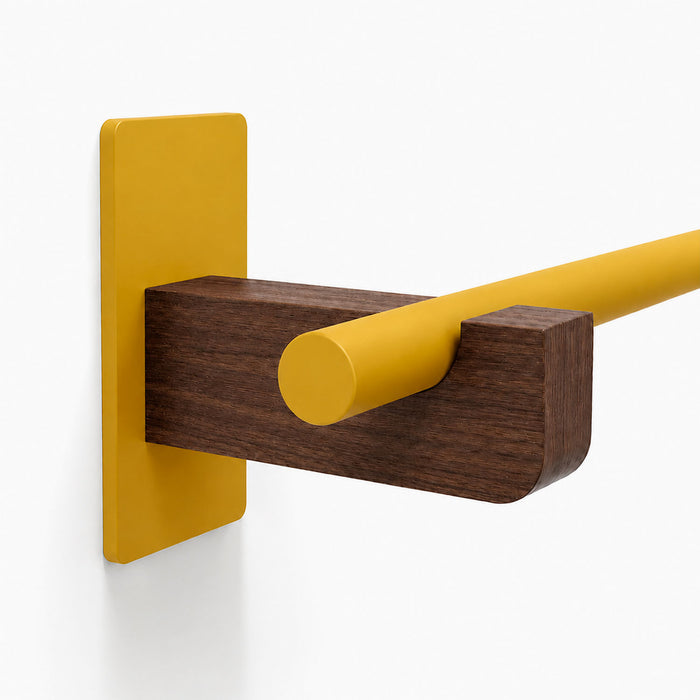 Close-up of Draper Curtain Rod System wall mount featuring a yellow metal rod held by a dark wood bracket and matching yellow metal base plate
