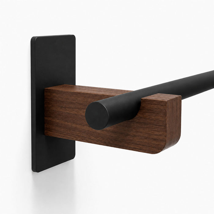 Close-up of the Draper Curtain Rod System showcasing its minimalist mixed-material design with a black metal rod and solid hardwood wall mount bracket.