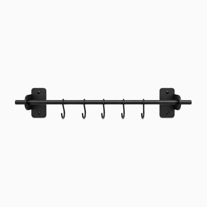 Etta Utensil Rack in matte black metal with five hooks, designed for durable wall-mounted kitchen organization and maximizing countertop space.