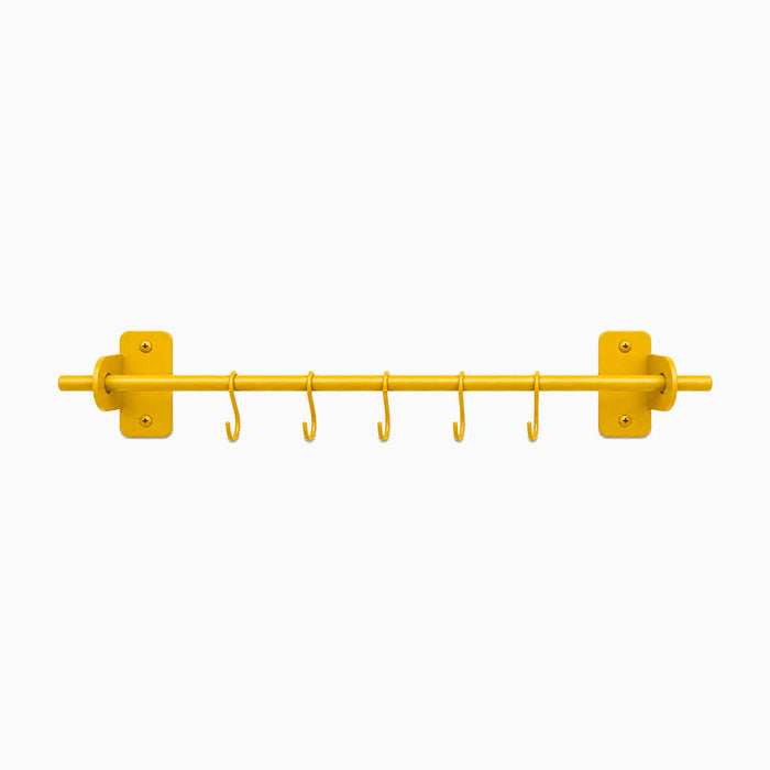 Etta Utensil Rack in honey mustard with six hooks and a minimalist design, crafted from durable metal for organized wall storage and display.