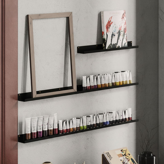 Fat Lippie Picture Ledge (3" Depth) in matte black steel floating shelves displaying art tubes and a frame on textured wall