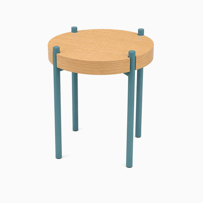 Fern Plant Stand (White Oak) with a round solid white oak top supported by four slender steel legs in soft blue for a modern minimalist look.