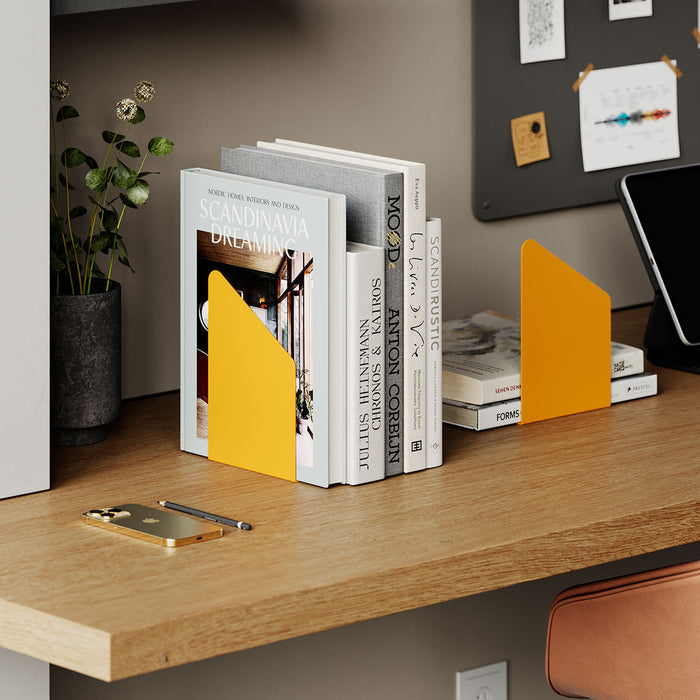 Geo Angle Bookend (Set of Two) in bright orange steel supporting books on a wooden desk for organized workspace shelves