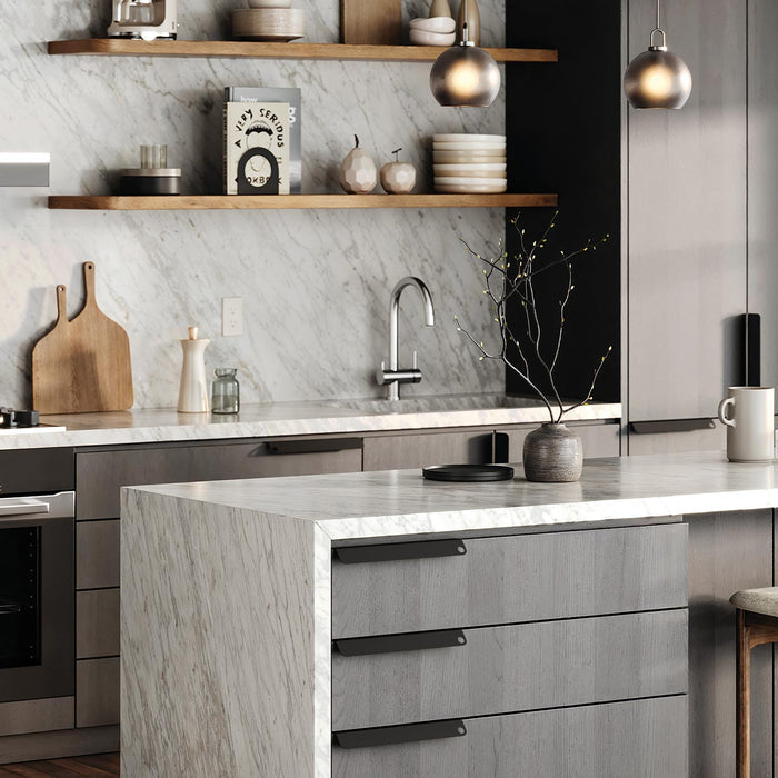 Peek Cabinet Pull in matte black steel mounted on gray wood drawers for modern kitchen hardware and efficient organization