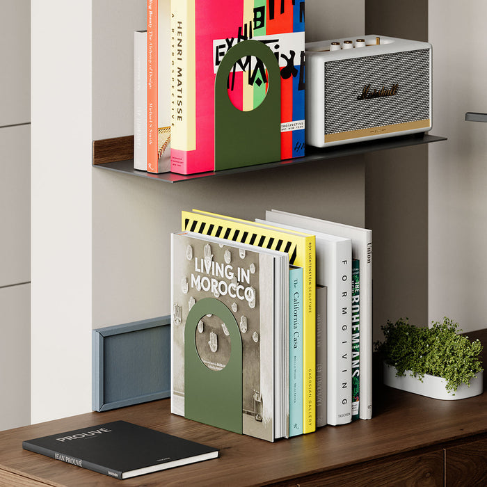 Geo Round Open Bookend (Set of Two) in olive green steel organizing colorful books on wood and metal shelves in modern space