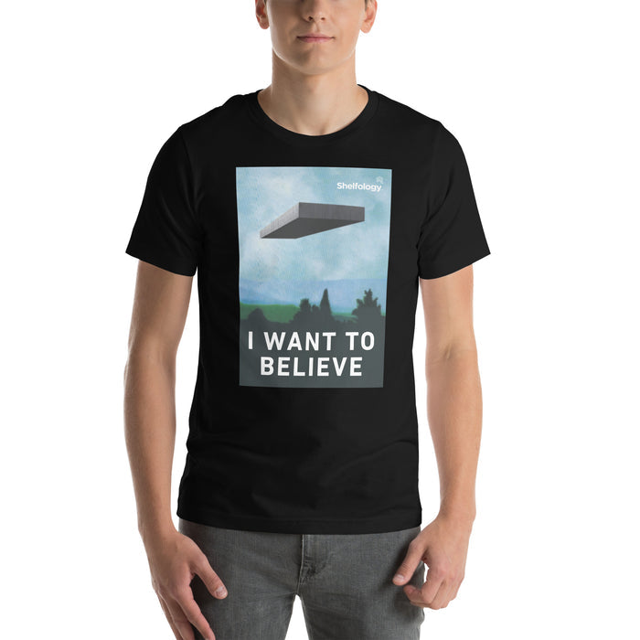 I Want to Believe T-shirt in black featuring a floating shelf graphic and bold white text for casual style
