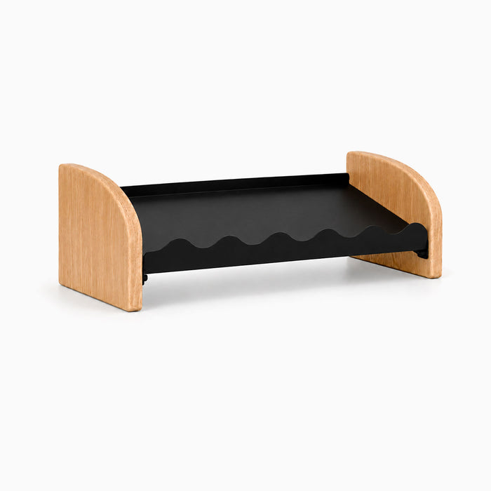 Kiddie Kicks Shoe Rack featuring solid hardwood side legs and a powder-coated steel shelf with wave-shaped grooves designed for organizing small kids’ shoes.