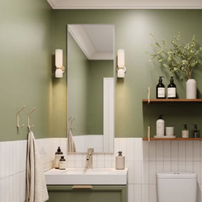 Modern bathroom featuring Lars Floating Vanity Hidden Mount Bracket supporting a wood and steel floating shelf with toiletries and greenery on an olive green wall.