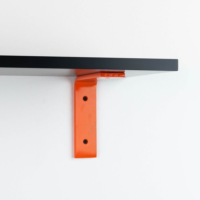 Leif Black Wall Shelf featuring satin clear alder wood and vibrant orange metal L bracket for bold wall display and organization