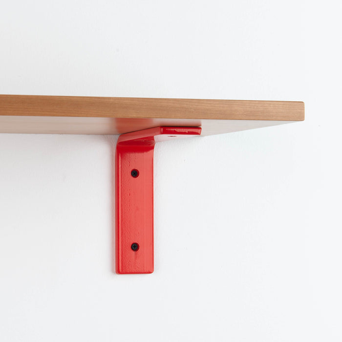 Leif Cherry Wall Shelf with smooth cherry wood and bold red metal L bracket for sturdy floating shelf display