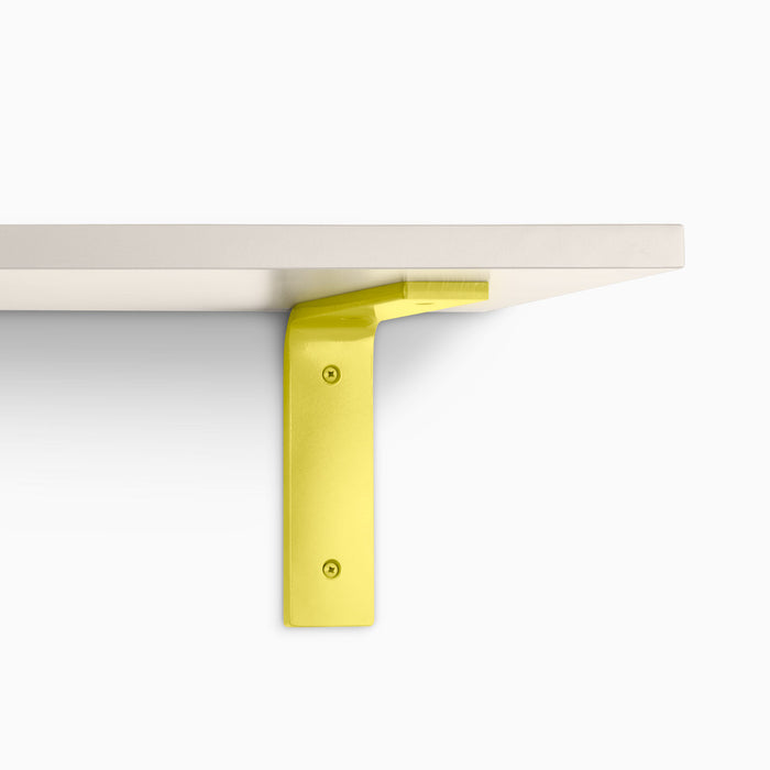 Leif Concretey Wall Shelf with satin clear alder wood and bright yellow metal L bracket for sleek wall shelf display and support