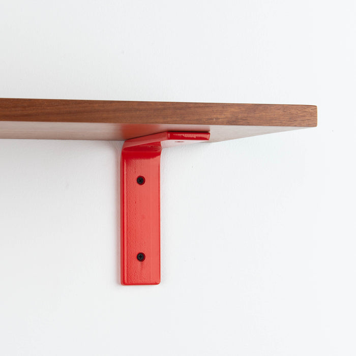 Leif Mahogany Wall Shelf with smooth mahogany wood and bold red metal L bracket for durable floating shelf display