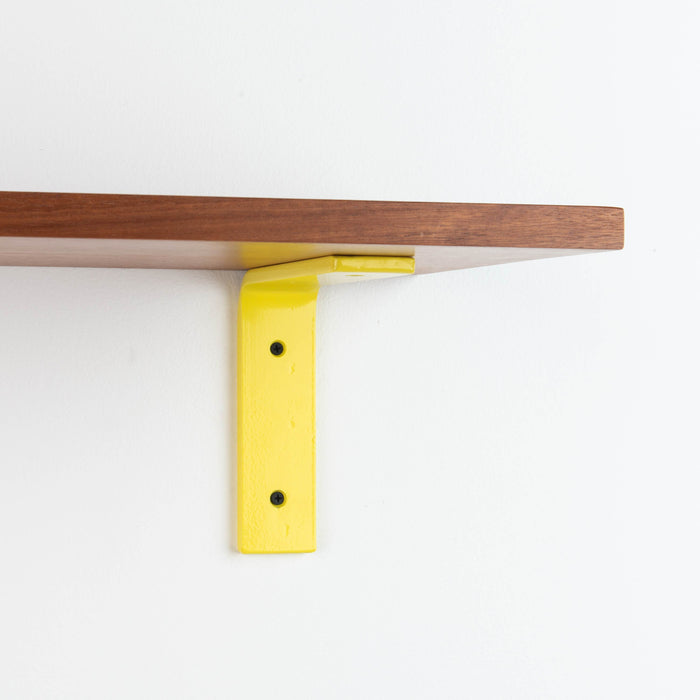 Leif Mahogany Wall Shelf with smooth mahogany glue-up and bright yellow metal L bracket for sturdy floating display