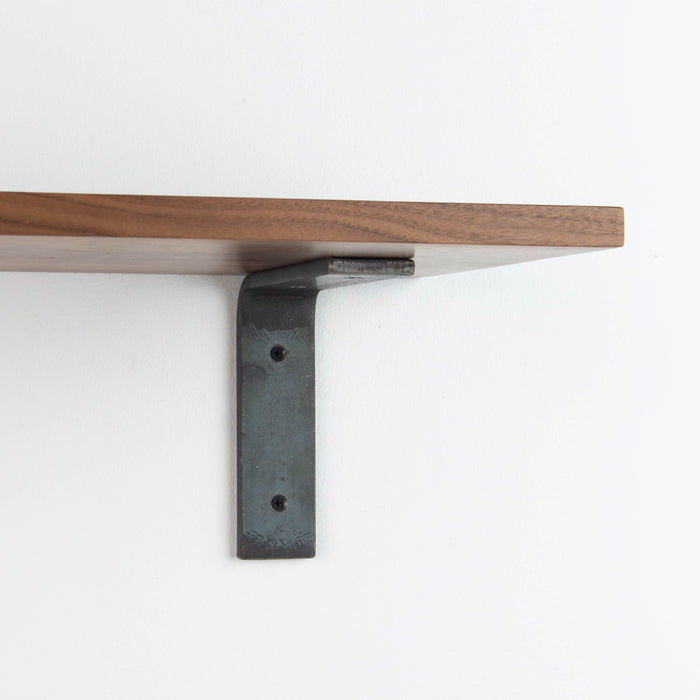 Leif Walnut Wall Shelf with smooth walnut glue-up and raw steel L bracket for sleek floating wall shelf support