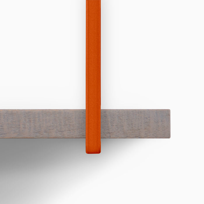 Lloyd Hatch Grey Rustic 5 Tiered Shelf showing textured grey wood ledge with vibrant orange metal floating shelf bracket detail