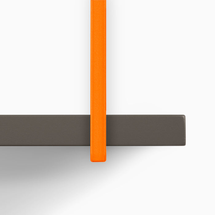Lloyd Tungsten 5 Tiered Shelf showing dark gray wood ledge with vibrant orange metal floating shelf bracket detail