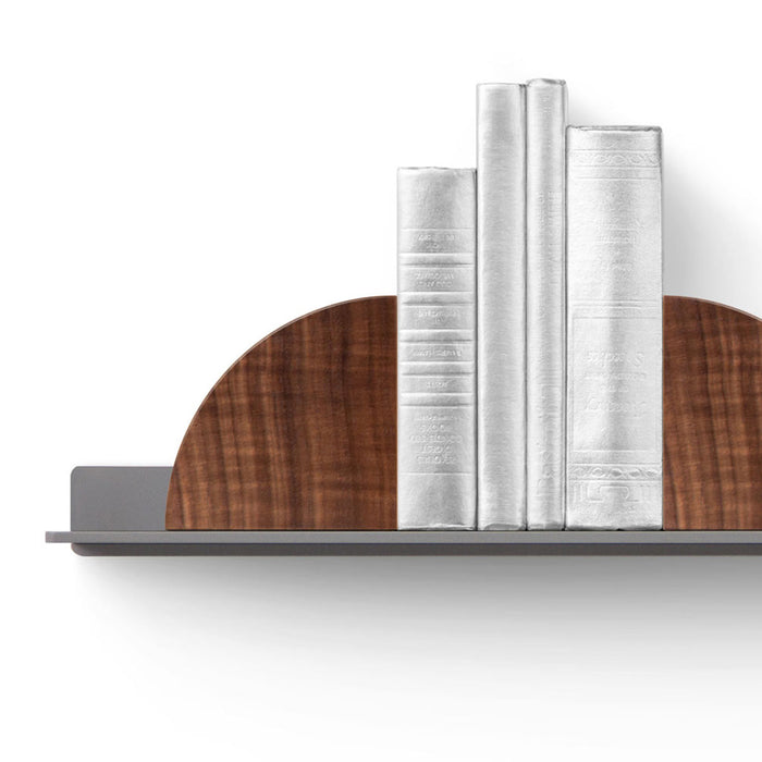 Straight on view of Walnut maggie radius products supporting 4 silver books.