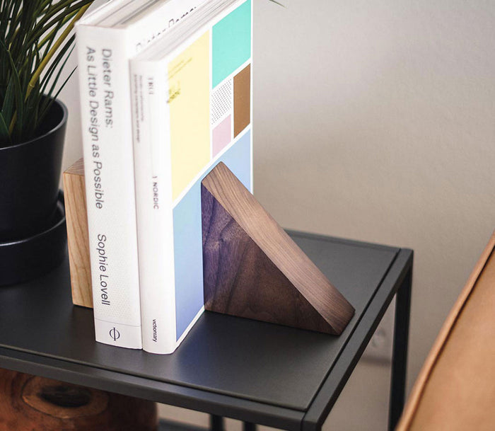 image of an end table holding two books and a plant, supported by a square and a triangle maggie bookend product