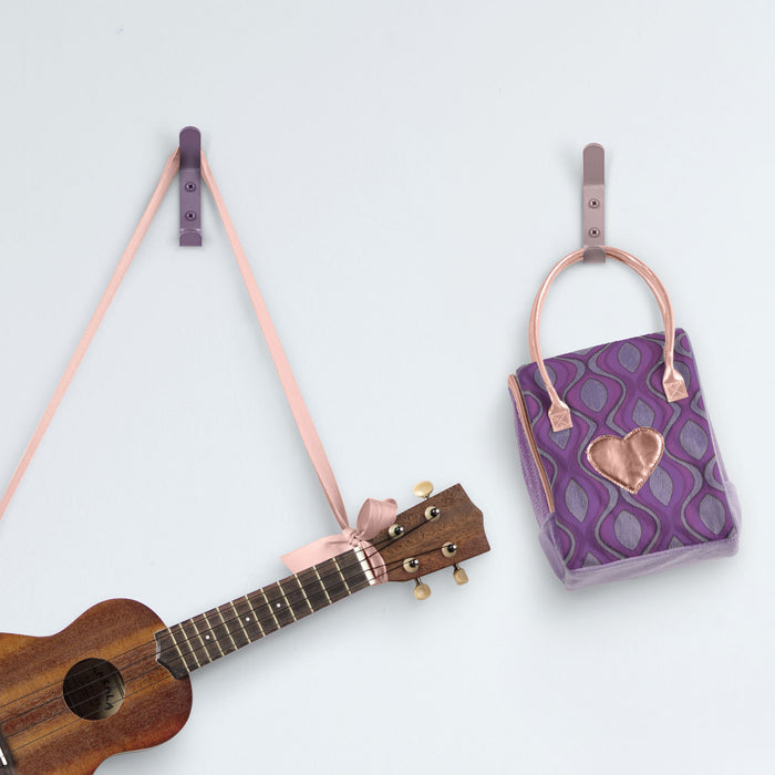 Mini Doohooky Wall Hook in muted purple steel holding a small purse and a ukulele strap for entryway organization by Shelfology