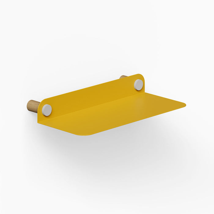 Morgan Basic Shelf with a smooth mustard yellow metal surface and natural wood rounded wall mounts, designed for functional, minimalist wall storage.