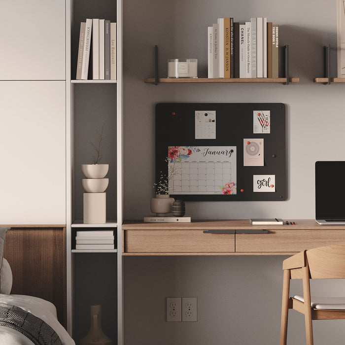 Mosey Magnet Board in dark steel mounted above wooden desk with calendar and notes in modern minimalist workspace by Shelfology