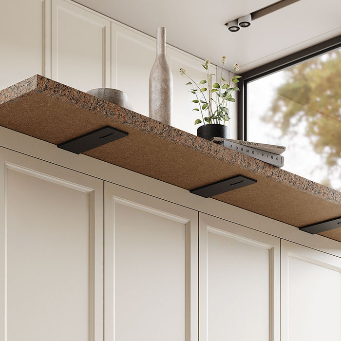 Otto Countertop Bracket in black steel supporting a thick granite countertop with minimalist decor, blending durable hardware with elegant design.