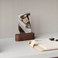 Pill Picture Holder with solid hardwood base displaying photo on clean desk with striped wall background and organizer folder nearby
