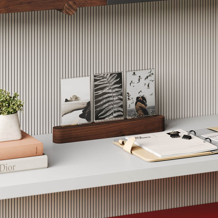 Pill Picture Holder with solid hardwood base displaying three photos on minimalist desk with books and planner nearby