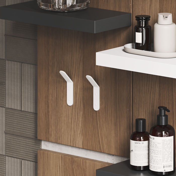 Popsicle Wall Hook in white mounted on wood panel with modern bathroom shelves and toiletry bottles by Shelfology